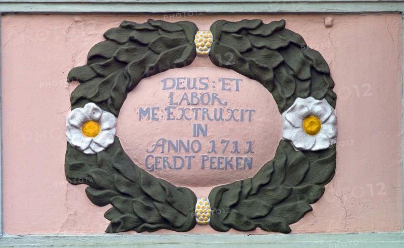 Ornament and inscription on an old dwelling house in Jever from 1711