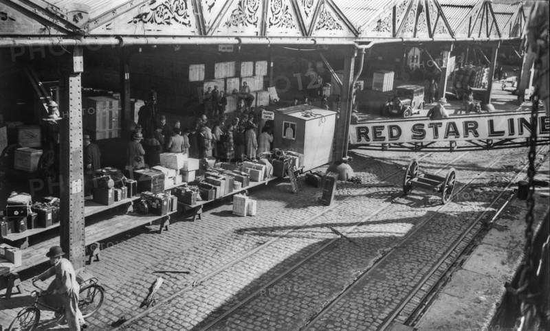 Old early 1900s photo of European emigrants travelling to the United States boarding steamship of the Red Star Line in the port of Antwerp