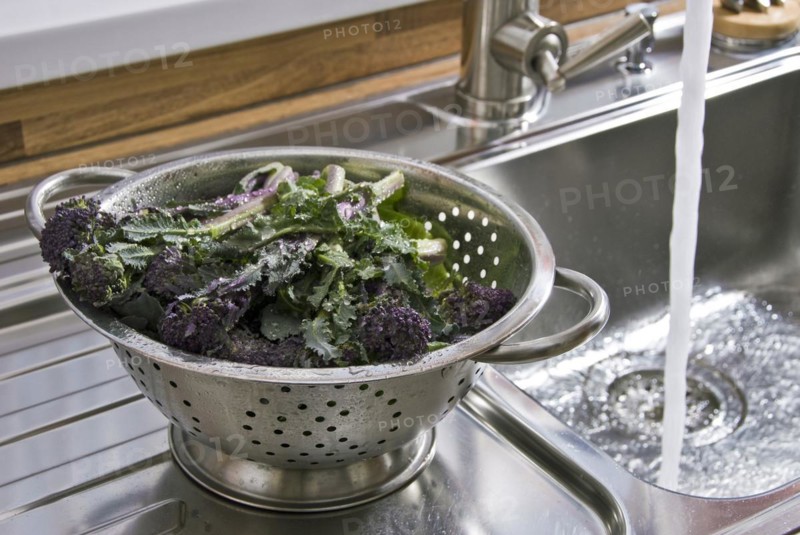 Washing vegetables in a stainless steel colander