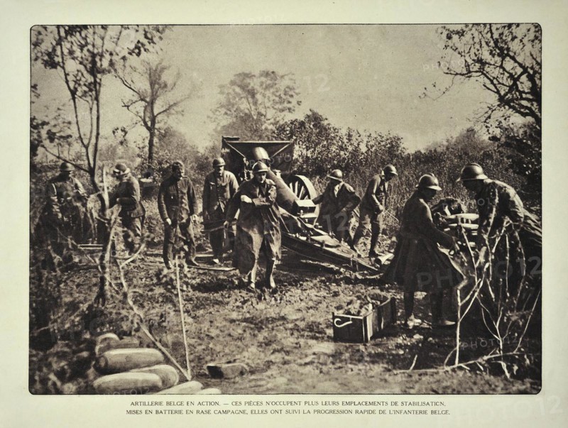 Artillery soldiers firing cannon at battlefield in Flanders during the First World War