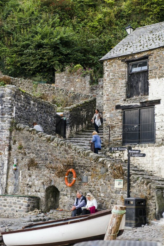 People relaxing and others negotiating the steeps cobbled streets of Clovelly