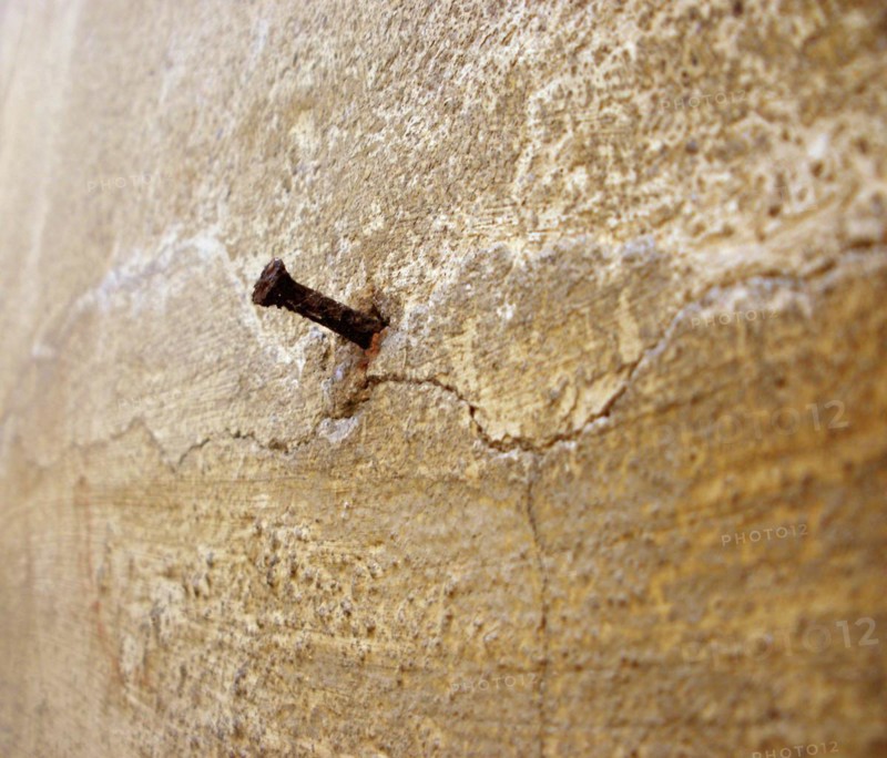 Rusty nail in wall