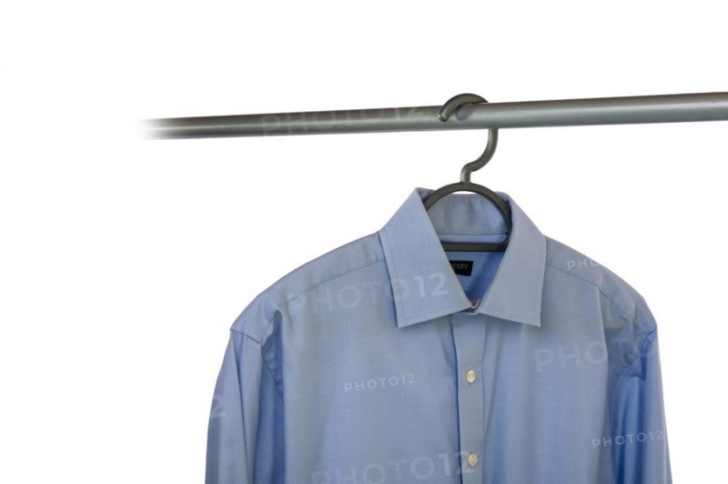 Business shirt hanging on a clothing rail and cut out on a white background