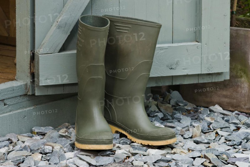 Pair of green wellington boots outside a garden shed
