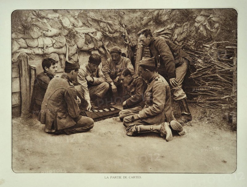 Soldiers at rest playing cards in trench in Flanders during the First World War