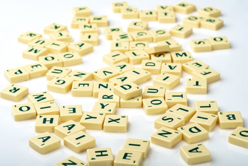 Scrabble tiles thrown down in a random chaotic way