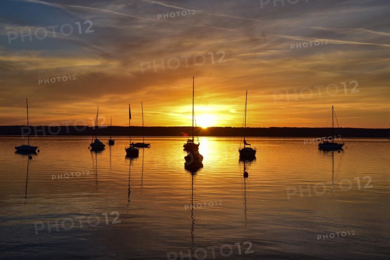 Sailing boats in the sunset in Herrschinger Bucht on Lake Lake Ammer