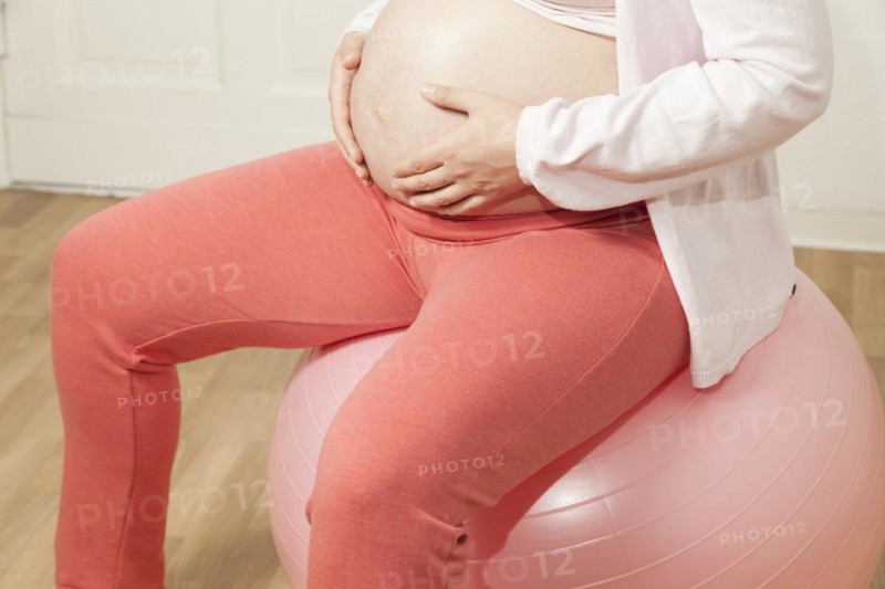 Pregnant woman sitting on an exercise ball