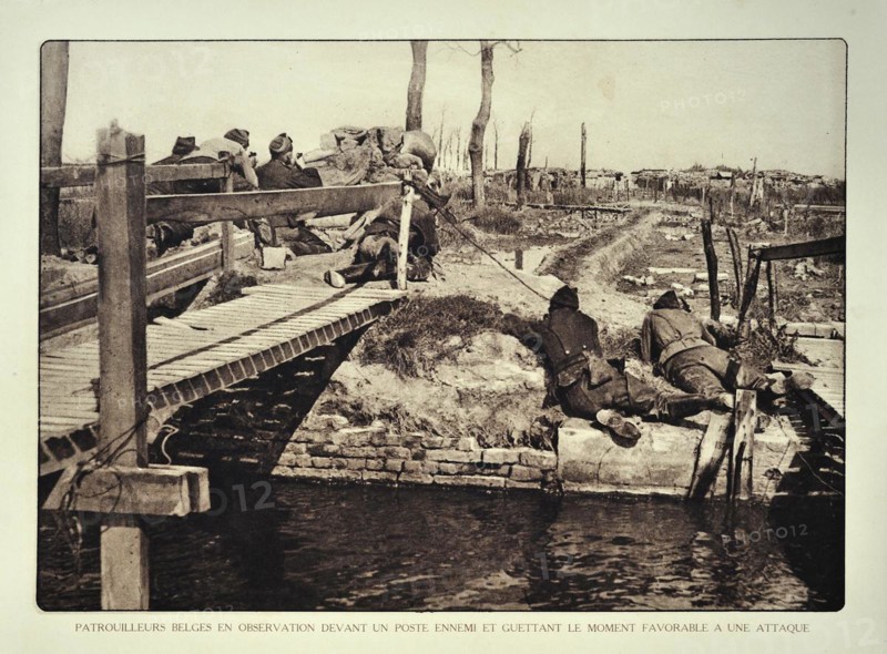 Soldiers on reconnaissance patrol observing the enemy from bridge in Flanders during the First World War