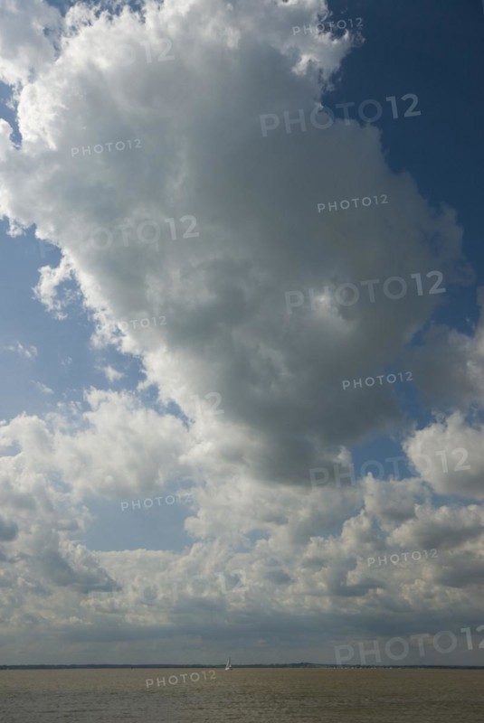 Small yacht under a large cloud