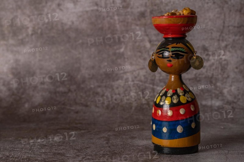 Hand-painted terracotta figure of a traditional handmade woman in close-up isolated close-up