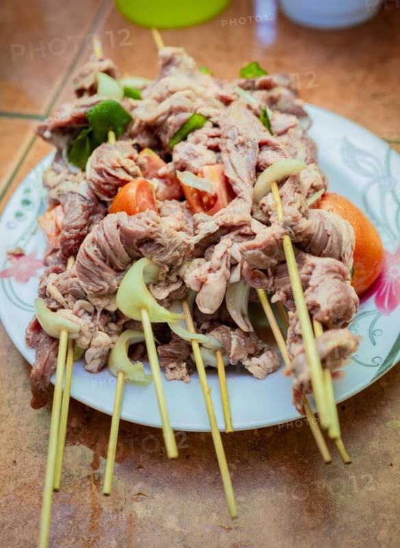 Raw beef skewers on a plate