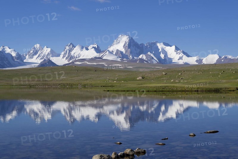 Kakshaal Too mountains reflecting in an alpine lake