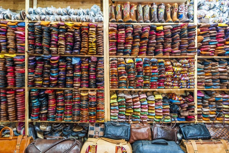 Colorful handmade leather slippers waiting for clients at shop in Fes