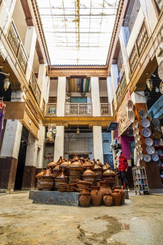 Shop in the courtyard with traditional tajine pot in the middle