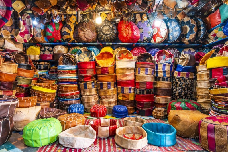 Variety of leather poufs sold in huge shop next to tannery in Fes