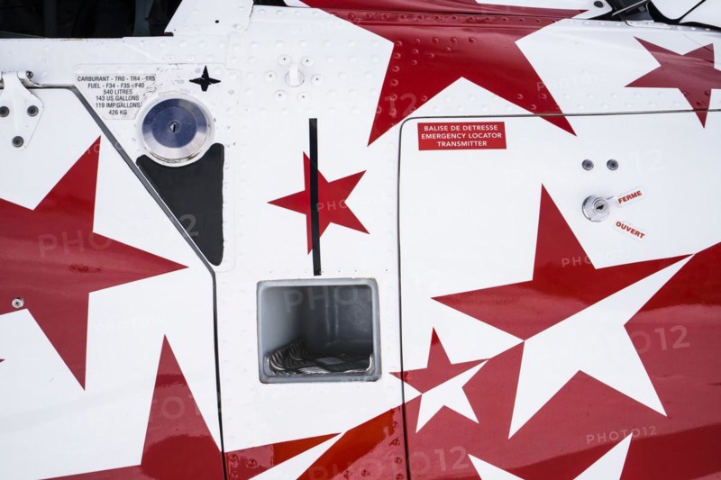 Swiss helicopter close up side view with red and white stars on chassis