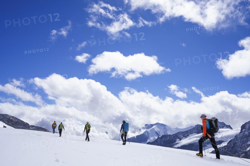 Alpine glacier hikers hiking on Aletsch Glacier
