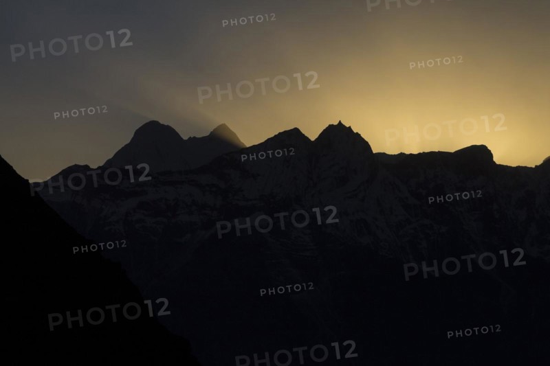 Kongde and other peaks of Rolwaling Himal backlit by the setting sun