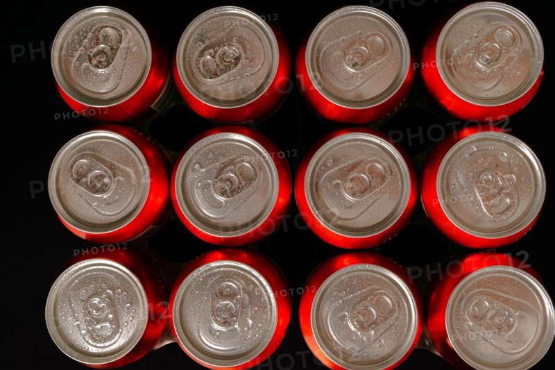 Group of fresh beer cans with drops of water with black background