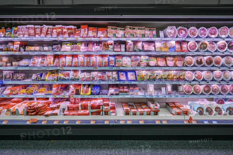 Shelf with sausages packed in plastic in a wholesale market