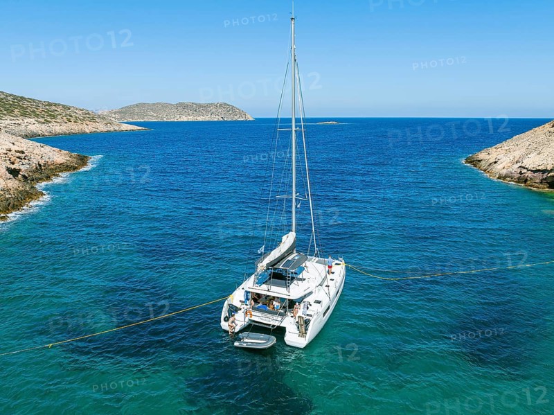 Sailing catamaran with shore lines