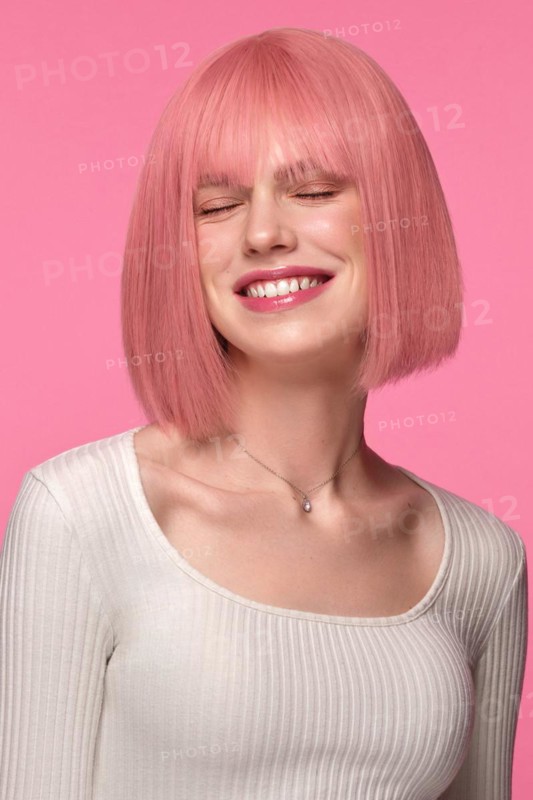 Beautiful funny cute woman in pink wig and classic makeup