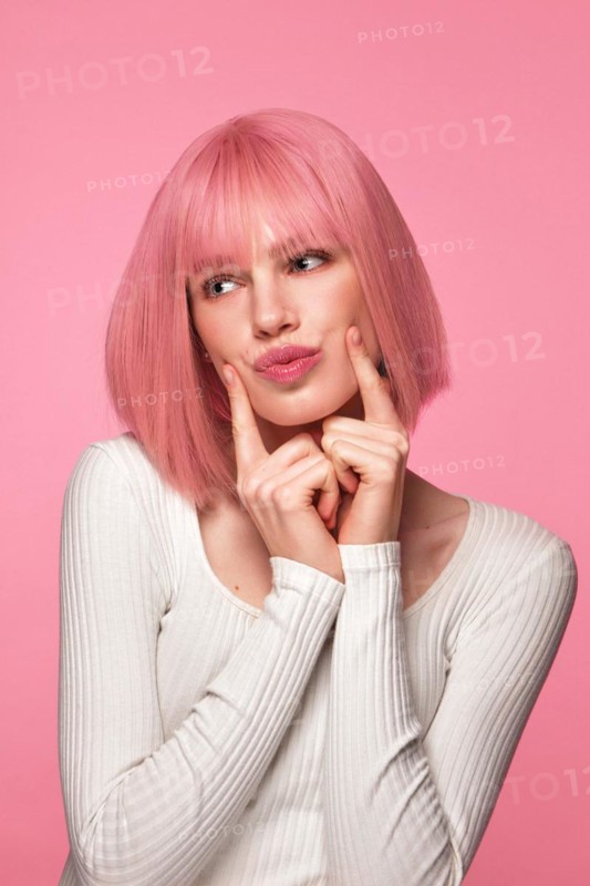 Beautiful funny cute woman in pink wig and classic makeup