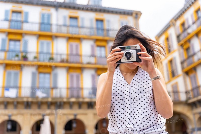 Tourist woman enjoying visiting the city looking at travel photos
