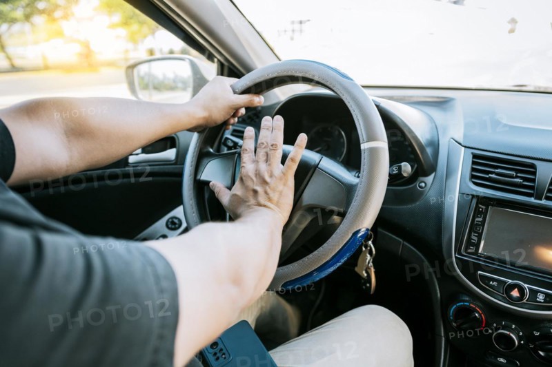 Driver man honking car horn