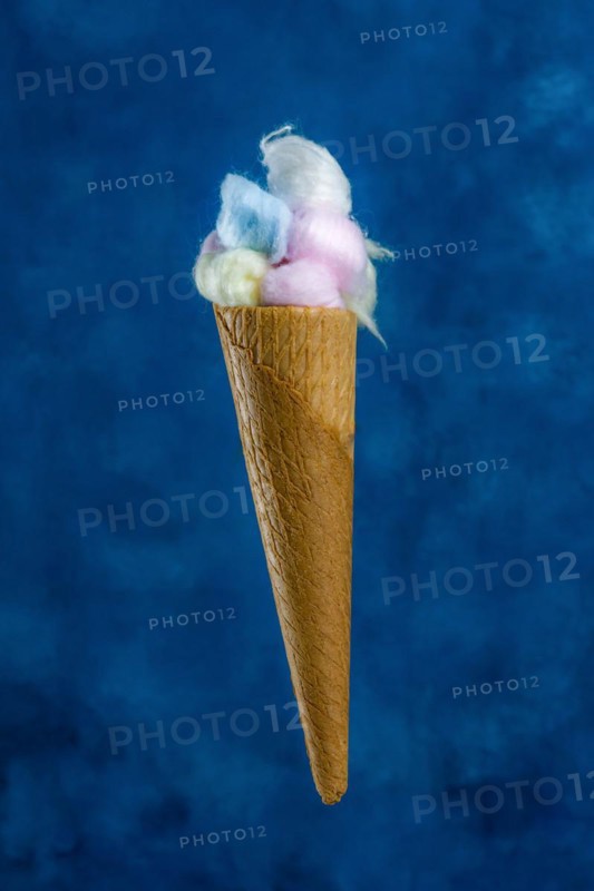 Colored cotton balls in various containers on a blue background