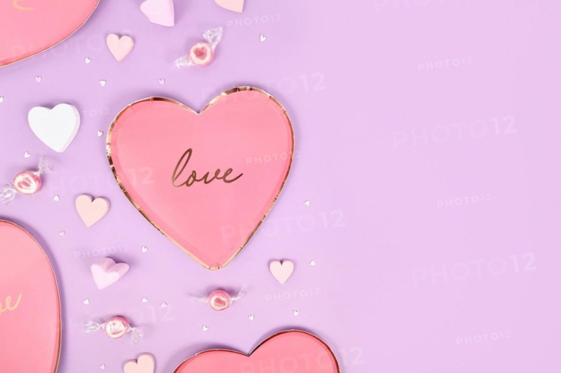 Pastel colored Valentine's Day flat lay with heart shaped plates