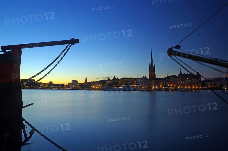 Illuminated harbour front at blue hour
