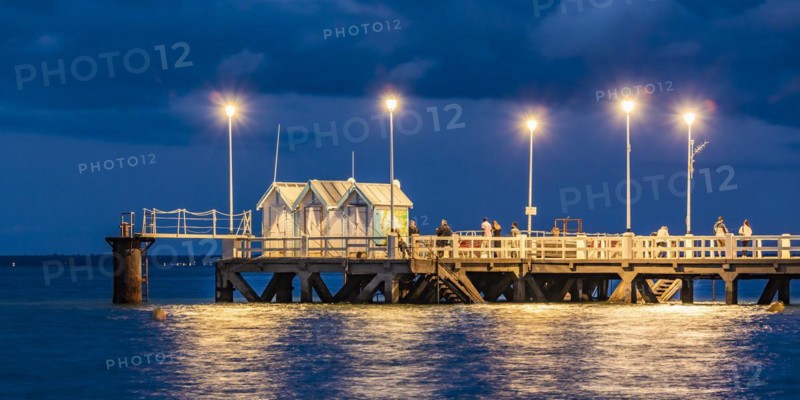 Anglers on a jetty in Arcachon in the evening