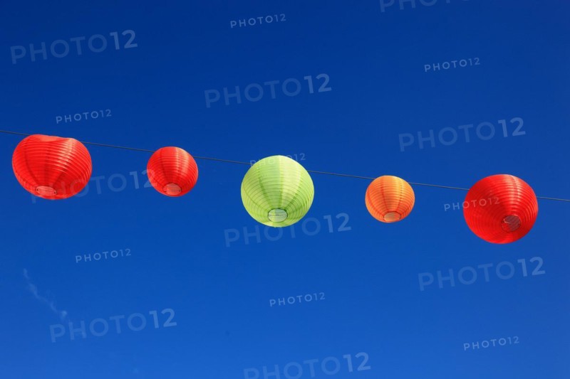 Colourful lanterns hanging on a line over the street