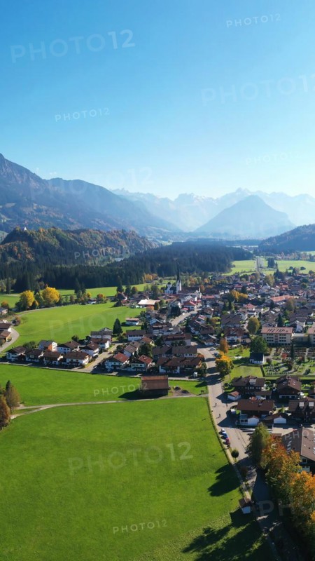 Aerial view of Fischen im Allgaeu with a view of the parish church of St Verena
