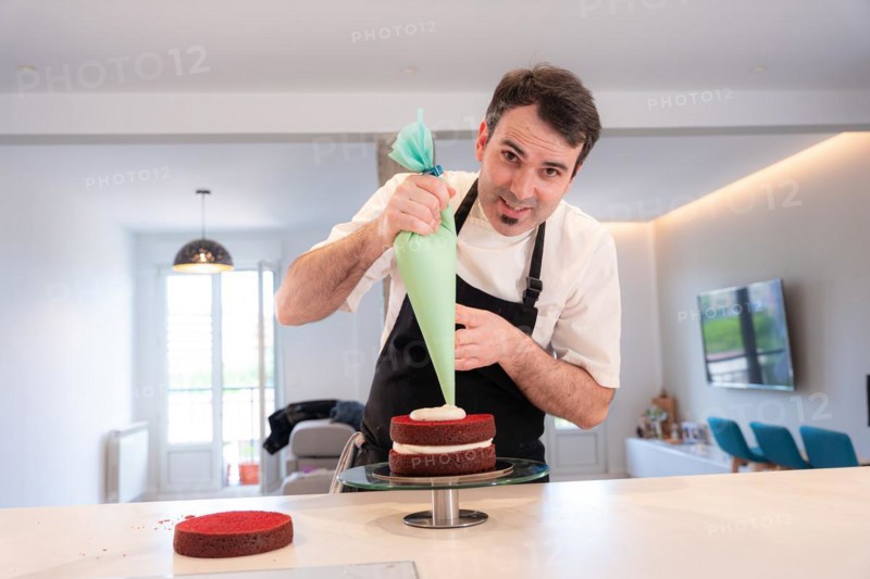 A challenger man bakes a red velvet cake at home
