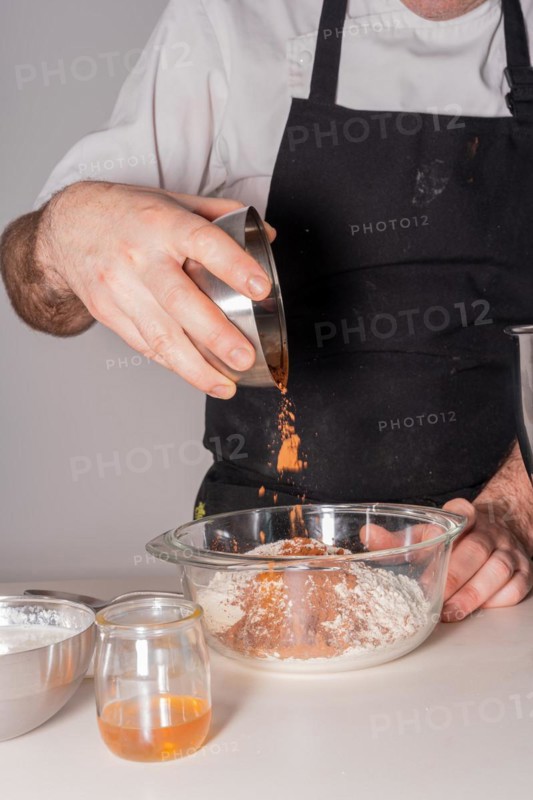 A man baker cooking a red velvet cake at home
