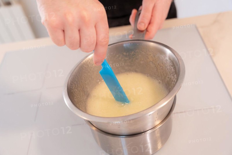 Hands of a man cooking a red velvet cake at home