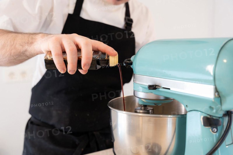 A man baker cooking a red velvet cake at home