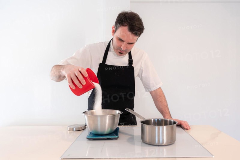 Hands of a man cooking a red velvet cake at home