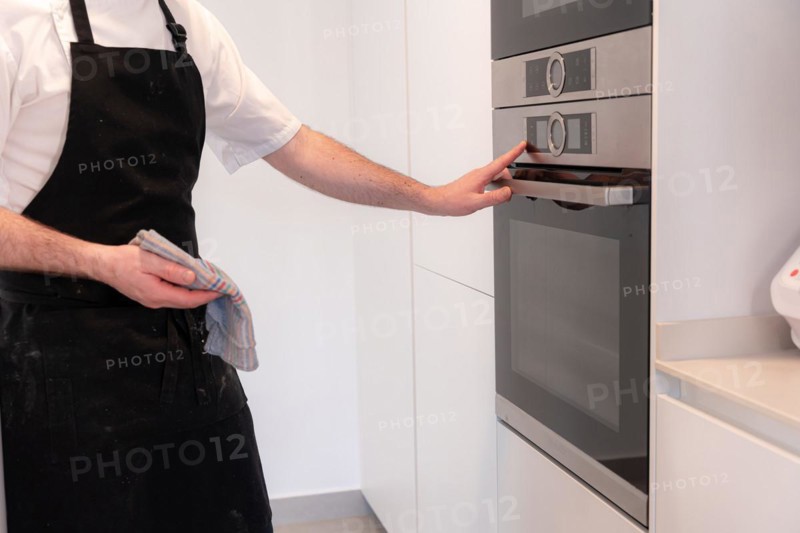 A man baker cooking a red velvet cake at home