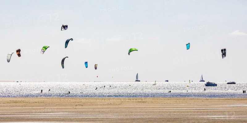 Group of kitesurfers kitesurfing in the Bay of Arcachon