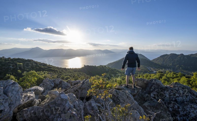 Hiker looking over volcanic peninsula Methana