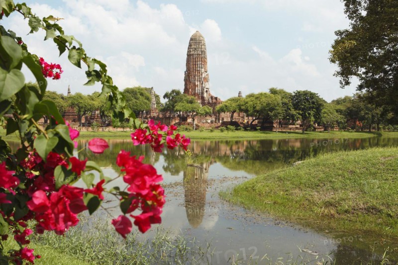 Prang of Wat Phra Ram reflected in the park lake