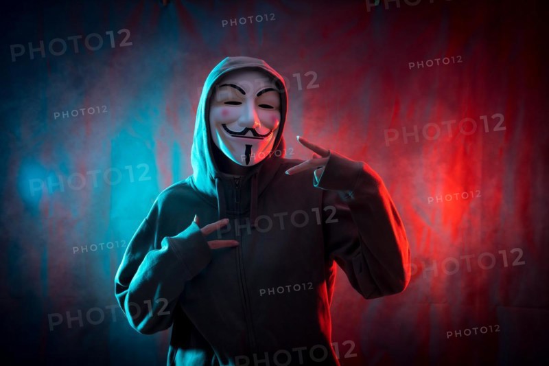 Hacker with anonymous mask making the victory symbol