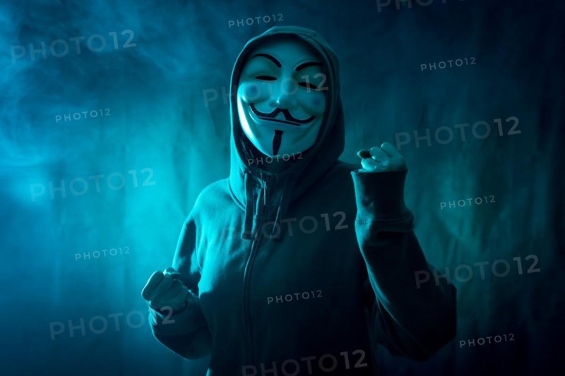 Hacker with anonymous mask with a symbol of fight