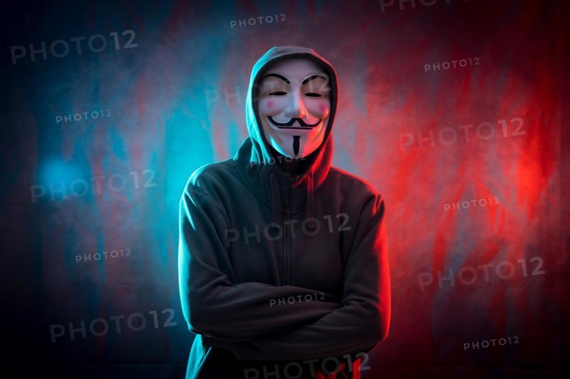Hacker with anonymous mask with arms crossed