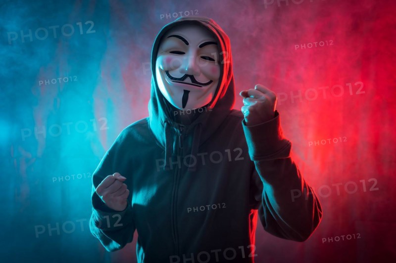 Hacker with anonymous mask with a symbol of fight
