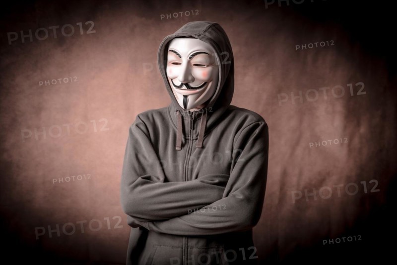 Man wearing anonymous mask with sweatshirt